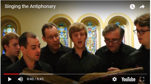 Image of a University of Michigan Choir Singing from a fifteenth-century antiphonary held at the Special Collections Research Center