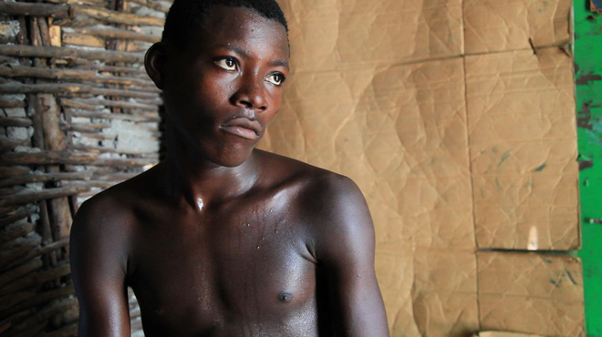 Screenshot of a shirtless Haitian boy from the film Children of Haiti.