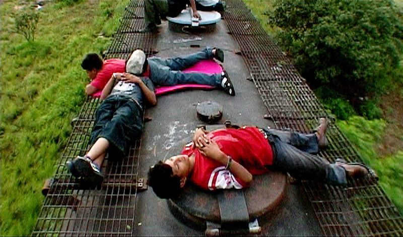 Screenshot of the characters in Which Way Home asleep on top of the train taking them to the United States.